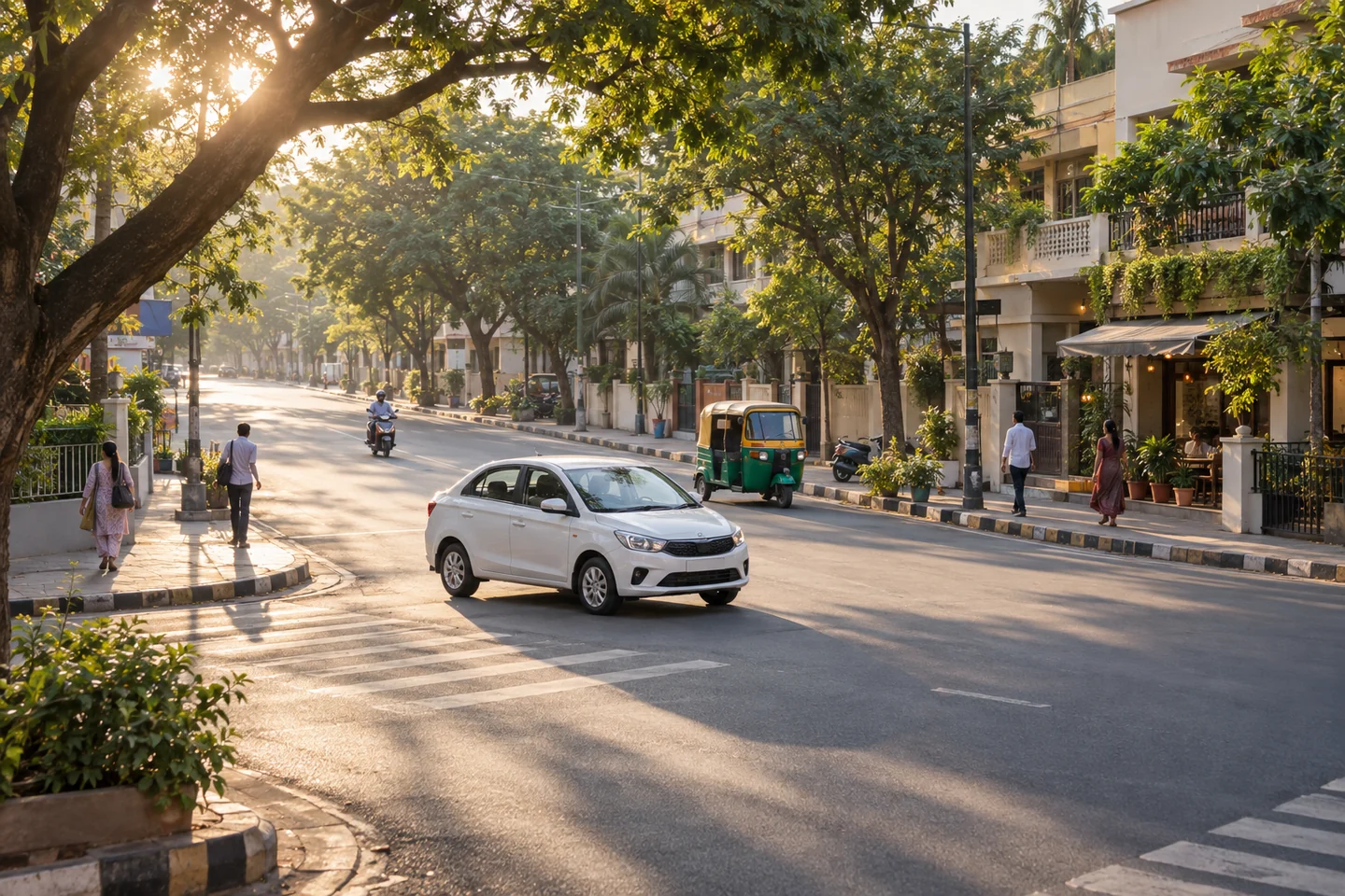 A white car and an autorickshaw on a tree-lined neighbourhood street.